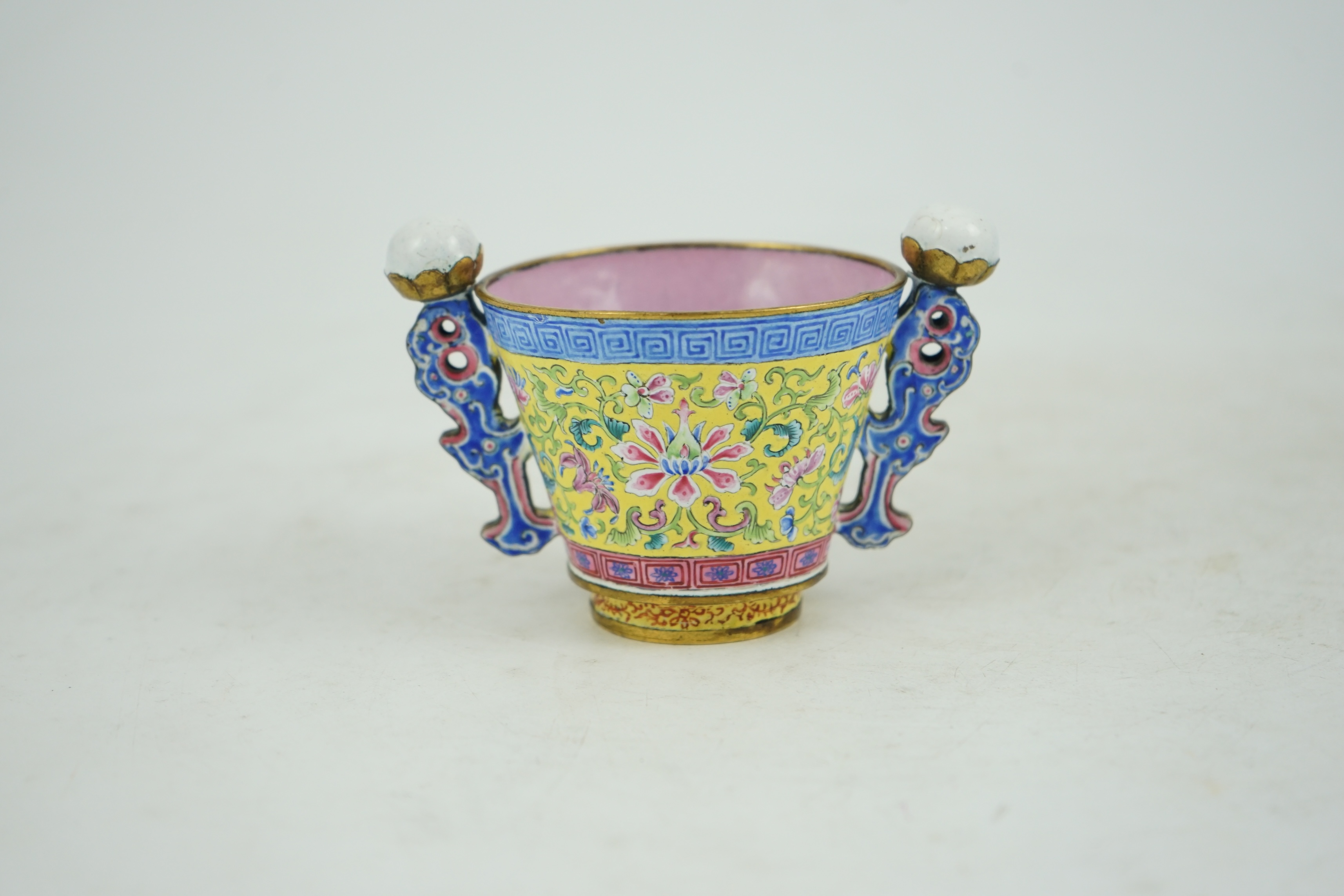 A Chinese Guangzhou enamel two handled wine cup, four character Qianlong mark and of the period (1736-1795)